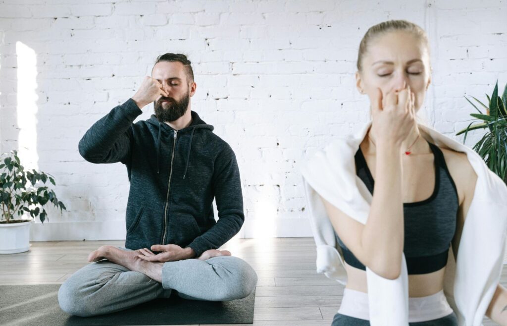 Man in Blue Zip Up Jacket Sitting Beside Woman in White Long Sleeve Shirtc